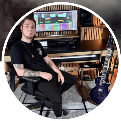 Chris Eternalis in his studio surrounded by guitars and production gear