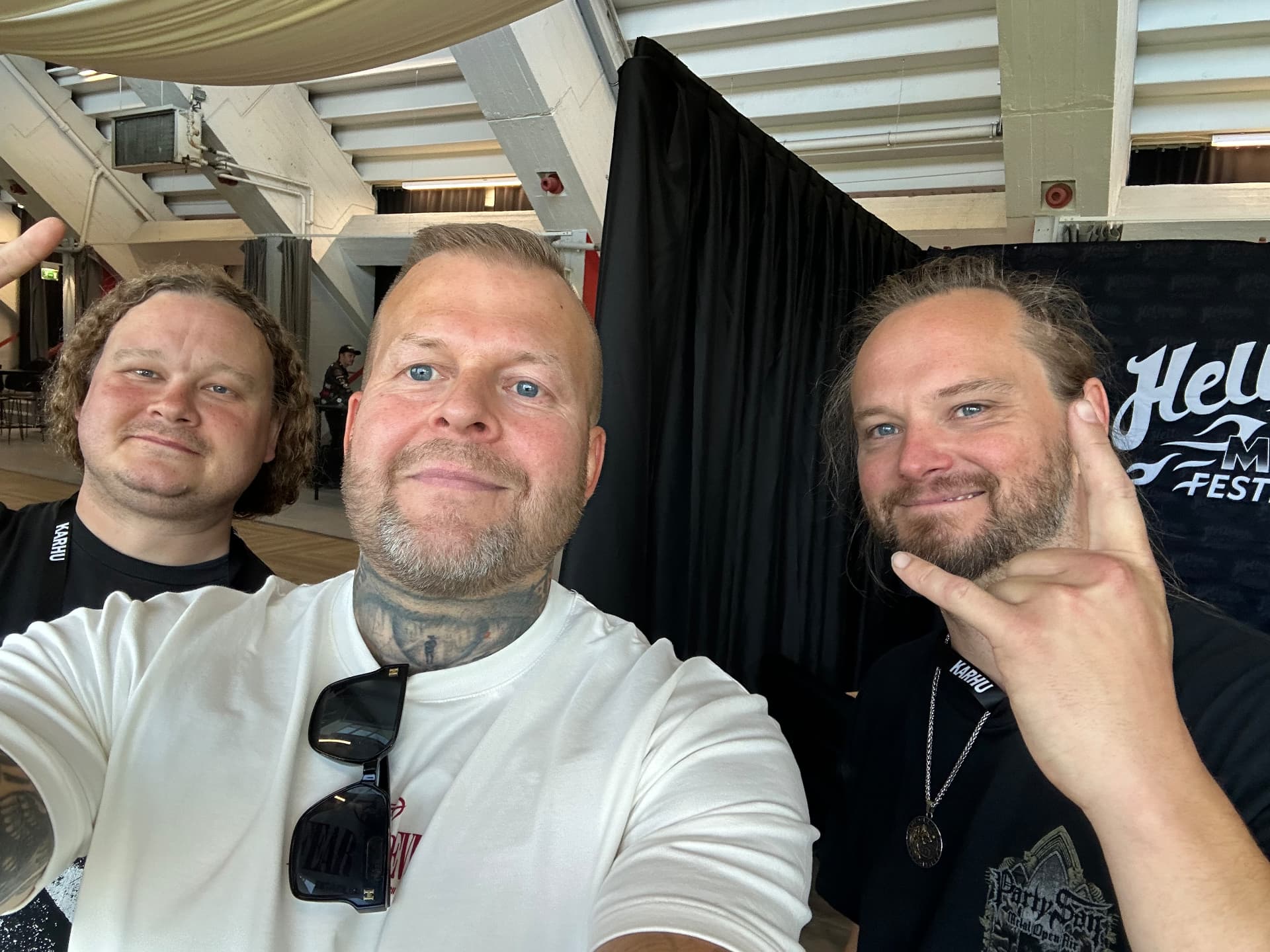 Exclusive interview — Iotunn's drummer, backstage at Hellsinki 2026. Tomi Perrakoski backstage with Iotunn's drummer at Hellsinki Metal Festival 2026 in front of the festival backdrop
