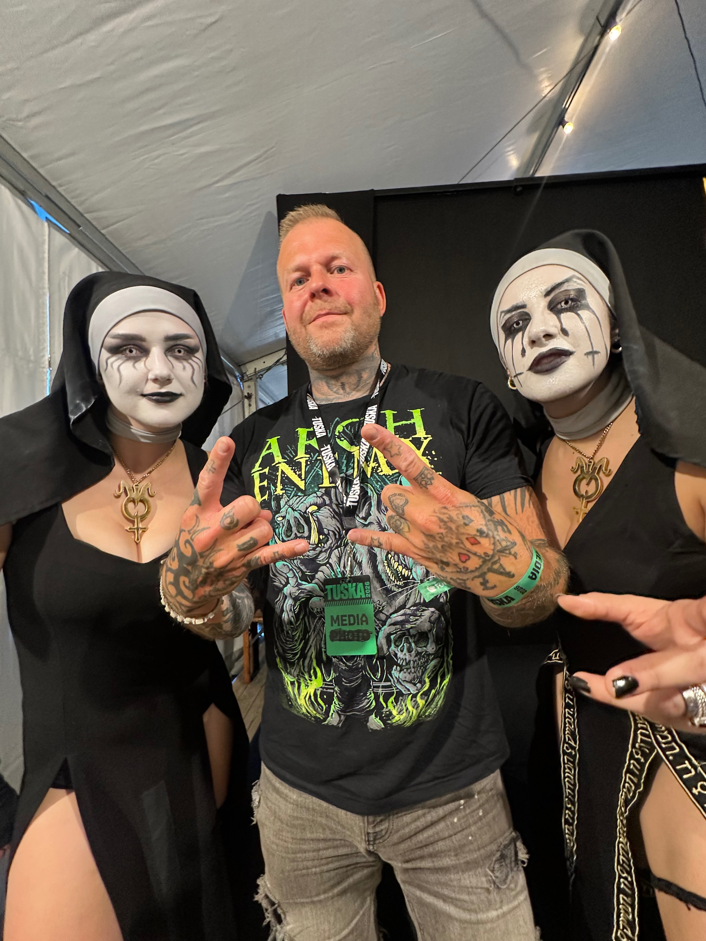 Tomi Perrakoski backstage at Tuska Festival 2026 with two members of Dogma in nun-style stage costumes and makeup