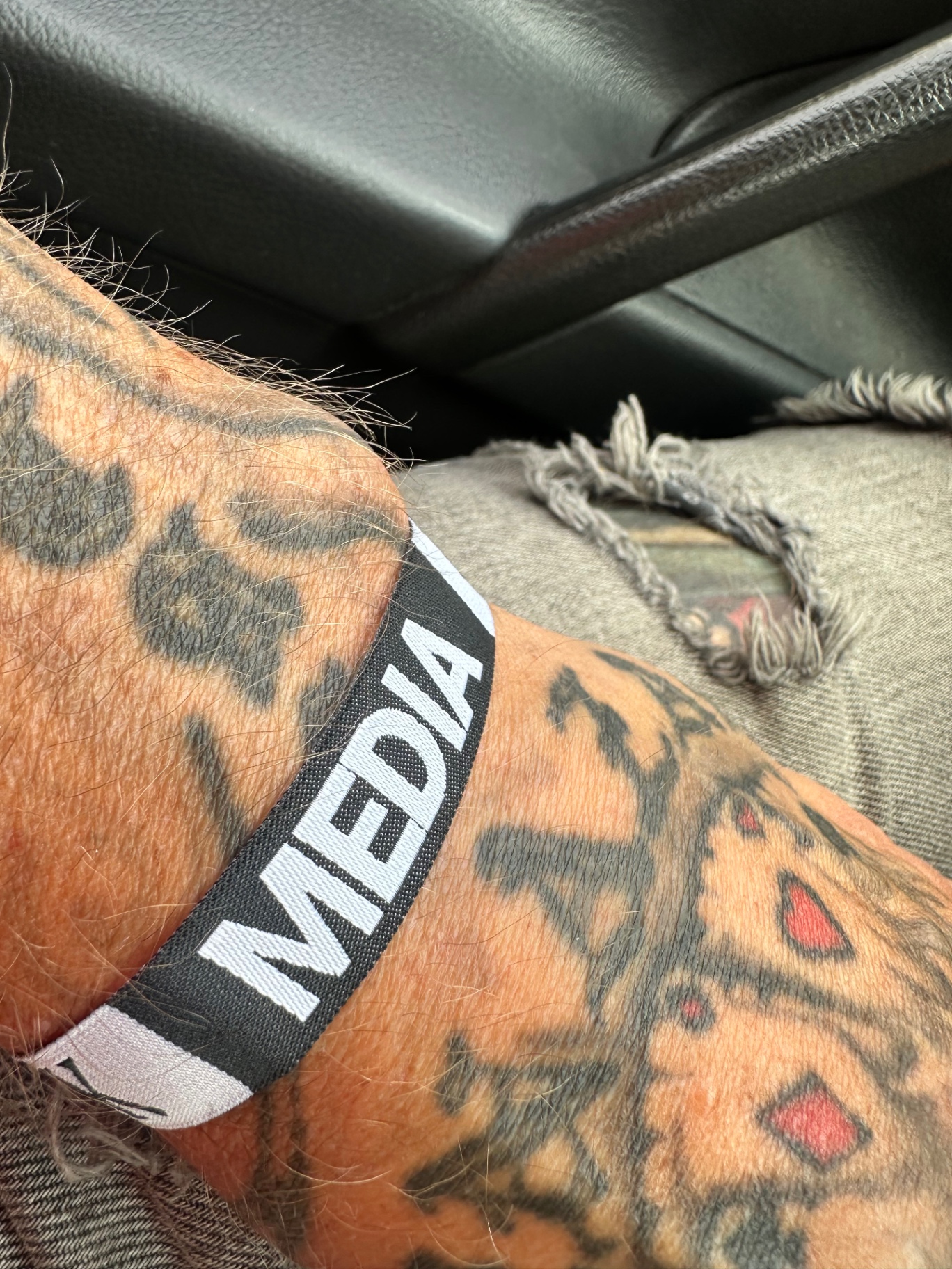 Media pass on — Day One begins. Metal Madness Weekly media wristband on tattooed arm — Ruisrock 2026