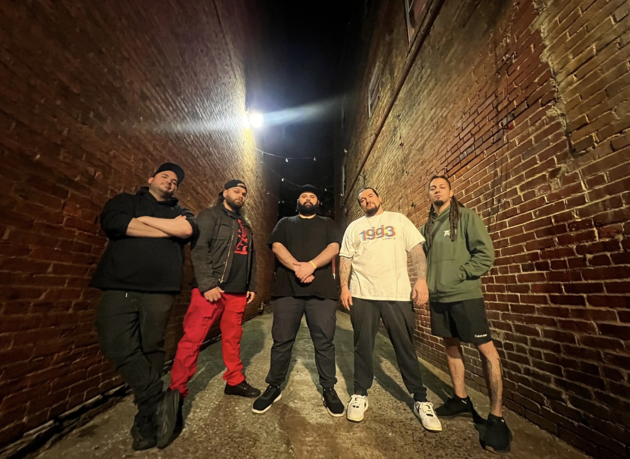 MODULES band photo — five members standing in a brick alley at night
