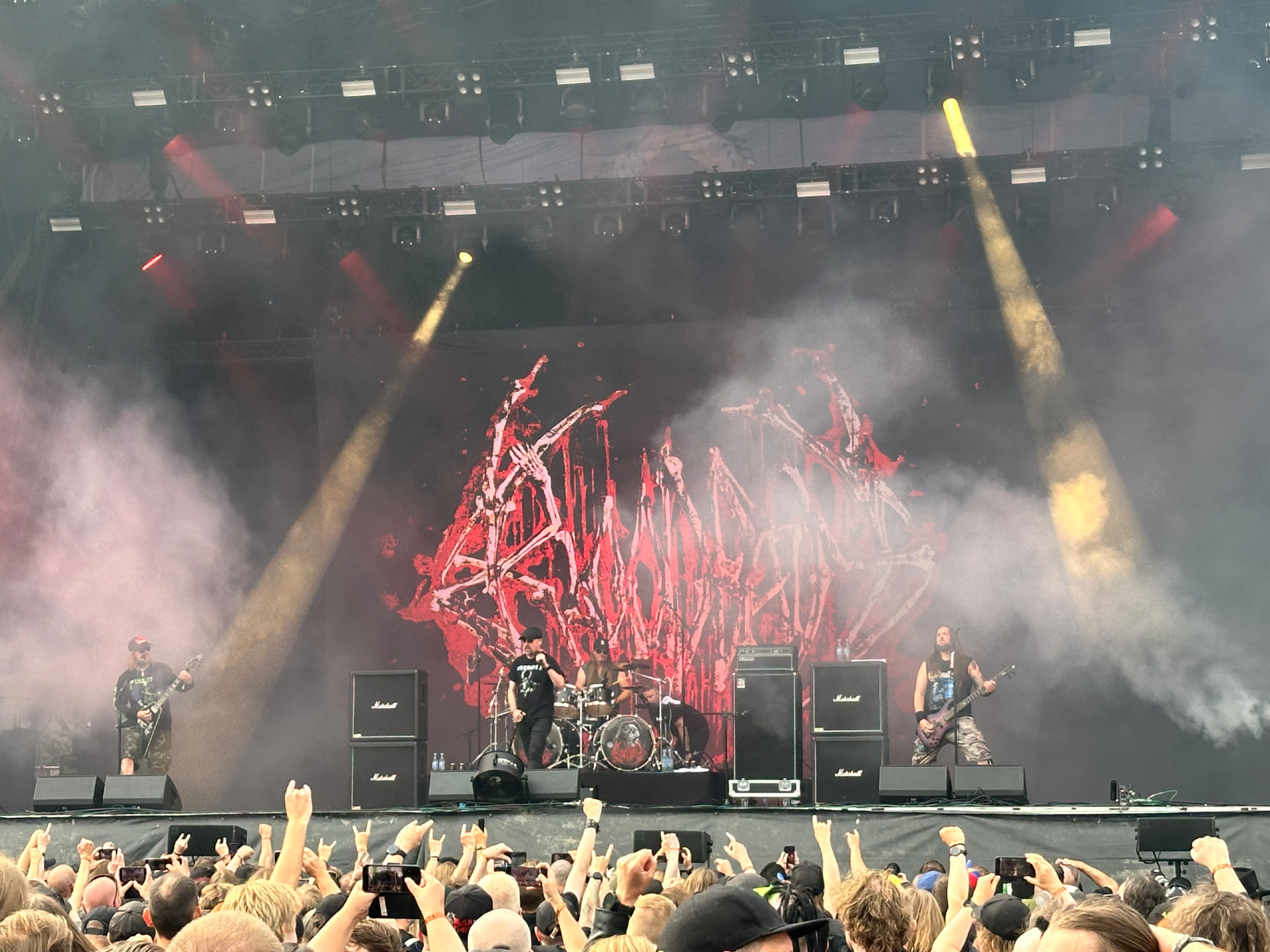 Bloodbath performing on the main stage at Hellsinki Metal Festival 2026 with a red backdrop and thousands of raised hands