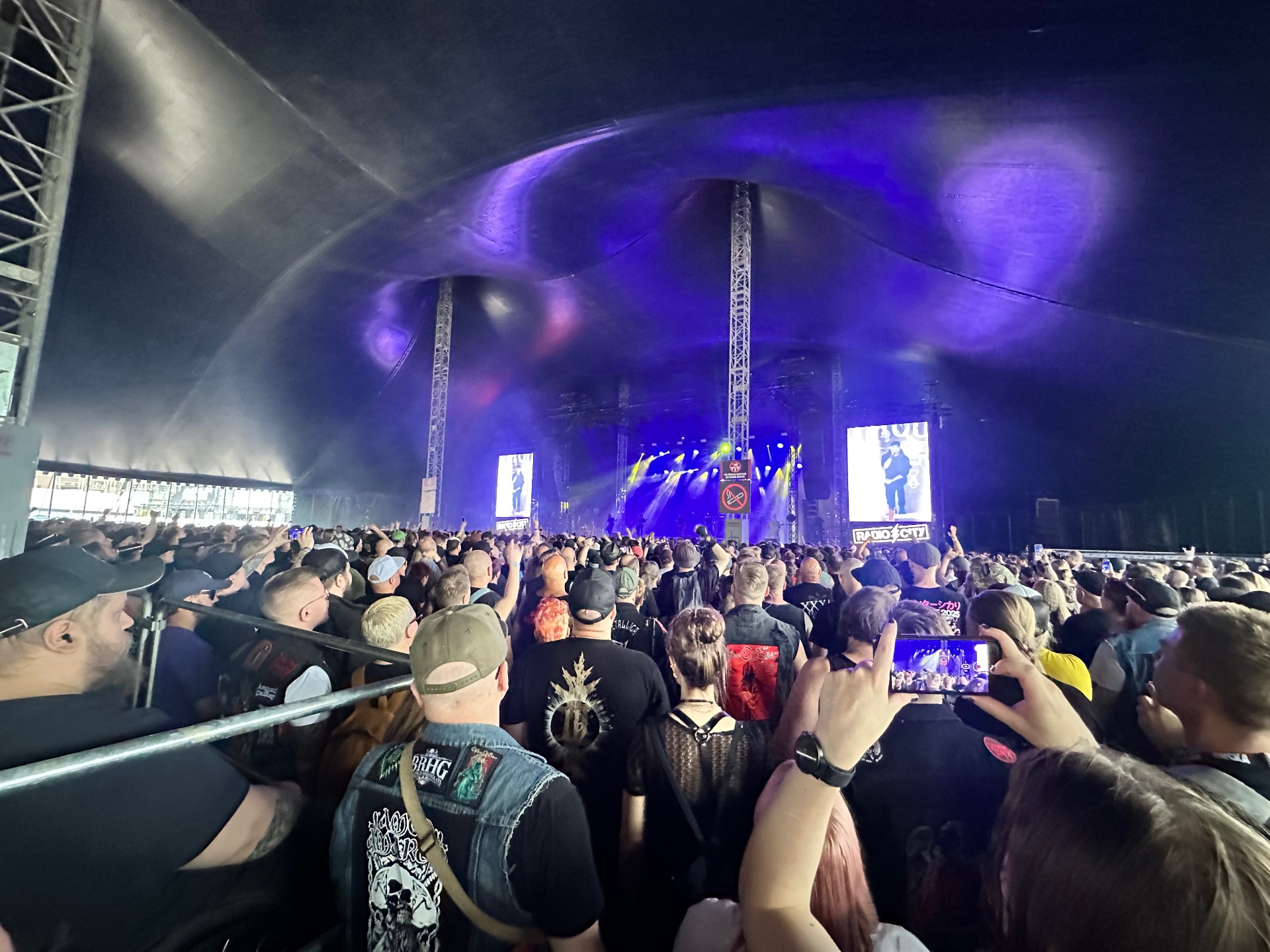 Bloodred Hourglass tearing through the tent stage in front of a packed crowd. Bloodred Hourglass (BRHG) performing under the Tuska tent stage at Tuska Festival 2026